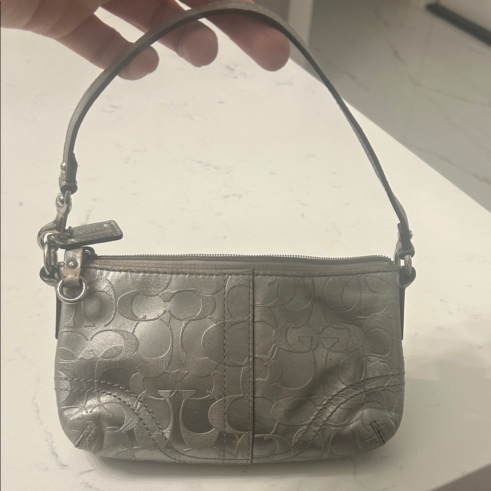 Silver leather small coach pouch .